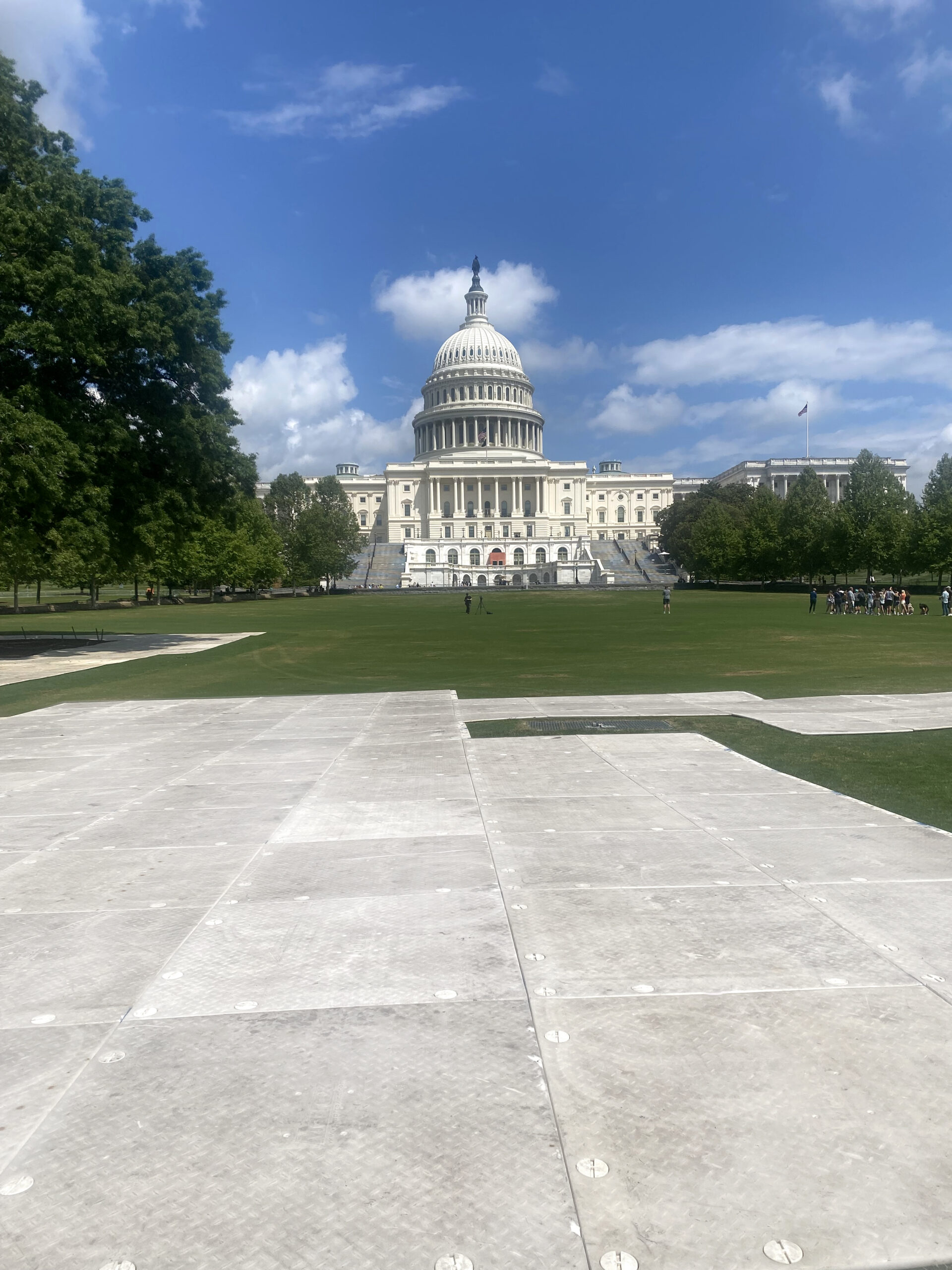 Protective flooring on field with White House in background.